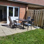 Terrasse mit Gartenmöbeln vor Ferienwohnung in Brake, ideal für entspannte Urlaubstage.
